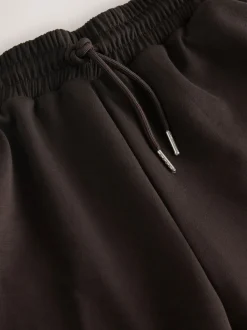 Chocoladebruin - Slinky trainingsbroek met wijde pijpen en zijstrepen