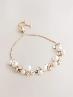 Goudkleurig - Doorgetrokken armband met pareleffect en glitters