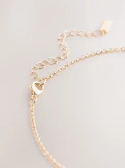 Goudkleurig - Ketting met hangertje van vereende ringen