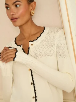 Ivoorkleurige en Zwarte geschulpte rand - Love & Roses gebreid vest