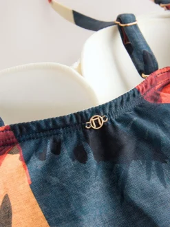 Marineblauw/oranje met palmprint - Vormgevend bandeaubadpak met buikcorrectie