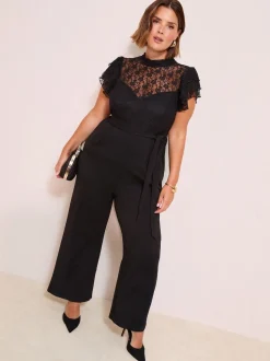 Zwart - Friends Like These jumpsuit van kant en scubamix met ruches aan de mouwen
